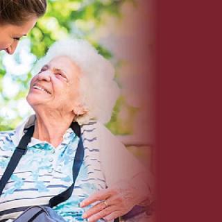 A caregiver and an elderly woman share a warm moment outdoors, highlighting the beauty of companionship and care.