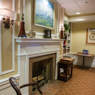 A cozy lobby area with a fireplace and elegant decor.