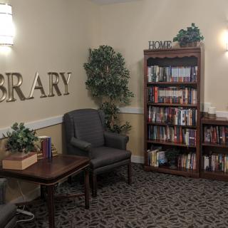 Cozy library corner with armchairs and bookshelves.