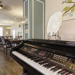 A stylish interior featuring a digital piano and elegant decor.