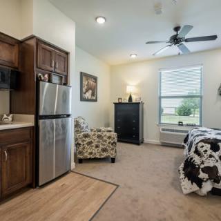 A cozy studio apartment with a modern kitchen and living area.
