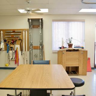 A physical therapy room equipped with various rehabilitation tools and exercise equipment.
