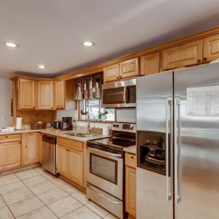 A modern kitchen with stainless steel appliances and wooden cabinets.