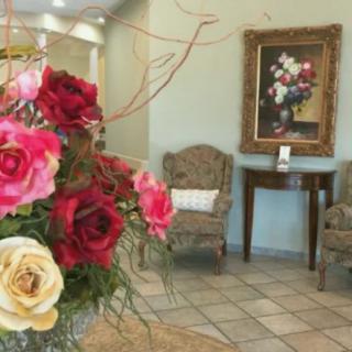 A beautifully decorated waiting room with a vibrant bouquet and elegant furnishings.