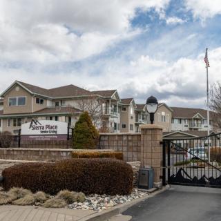 A view of a gated residential apartment complex with a cloudy sky in the background.