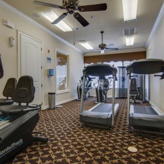A small gym with treadmills and exercise equipment.