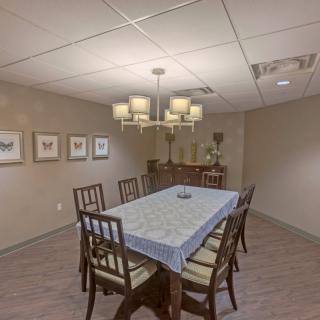 A cozy dining room with a table set for six and elegant decor.