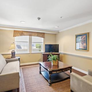 A cozy living room with a sofa, coffee table, and television.