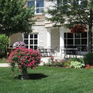 A picturesque garden with vibrant flowers in front of a modern house.