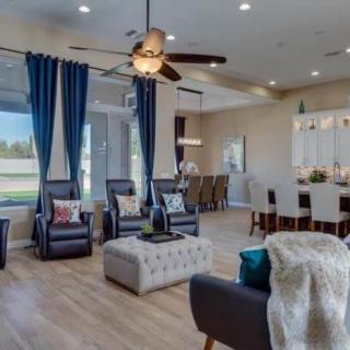 A modern living room with stylish furniture, featuring a seating area and an open layout.
