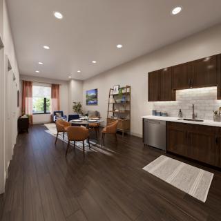 A beautifully designed open-concept living area featuring a modern kitchen and cozy seating arrangement.