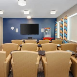 A cozy home theater with comfortable seating and a large screen.
