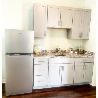 A modern kitchen with sleek cabinets and a stainless steel refrigerator.