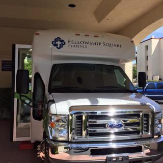A medical transport bus parked outside a building.