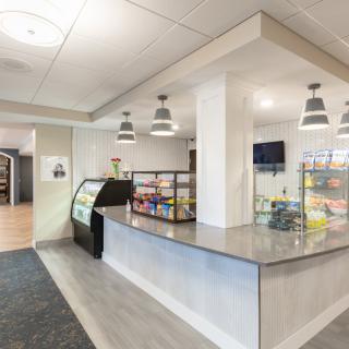 A modern cafe interior with a counter and seating area.