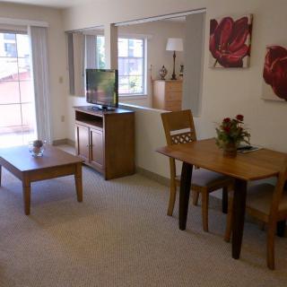A cozy living space with a dining table, television, and tasteful decor.