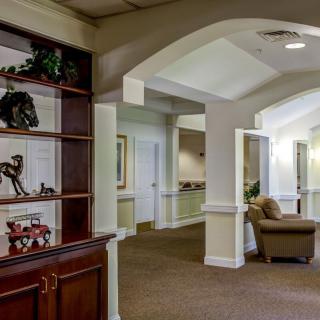 A spacious and well-lit office lobby featuring comfortable seating and decorative elements.