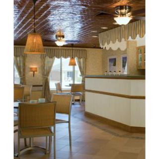 A cozy restaurant interior featuring wooden furniture and soft lighting.
