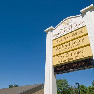 A health and rehabilitation center sign detailing health, rehab, assisted living, and elder care services.