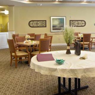 A well-decorated dining area with round tables, chairs, and elegant decor.