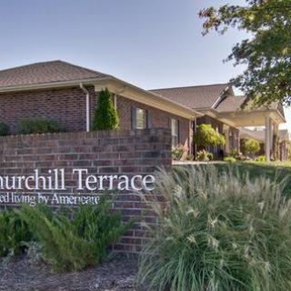 Entrance to Churchill Terrace with landscaped surroundings and a brick sign.
