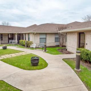 A peaceful courtyard with landscaped gardens and adjoining buildings.
