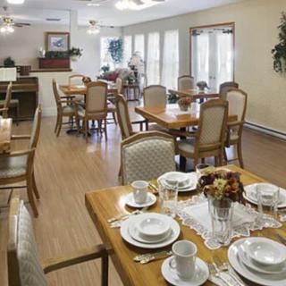 A spacious dining area with neatly arranged tables and chairs, ready for guests.