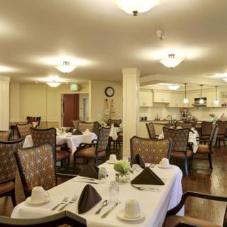 An elegant dining room setup with neatly arranged tables and chairs.