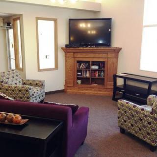 A cozy living room with comfortable seating and a television.