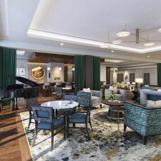 A modern hotel lobby with elegant seating and a grand piano.