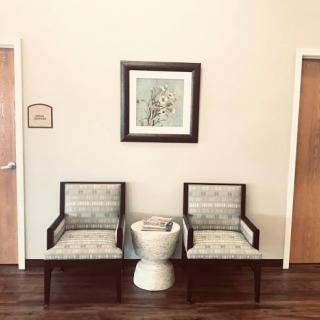 A quirky waiting area featuring two chairs and an unexpected centerpiece.