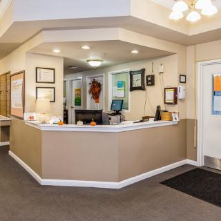 A reception area with a central desk and interior decor.