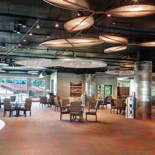A spacious and modern restaurant interior with stylish ceiling lights and comfortable seating.
