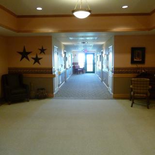 A well-lit hallway with seating and decorative elements.