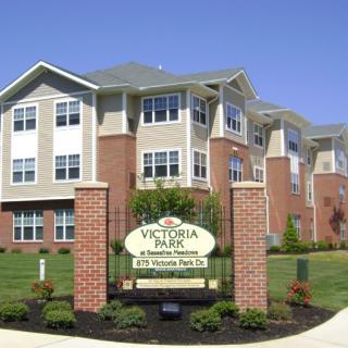 Victoria Park apartment complex with a neatly landscaped entrance.