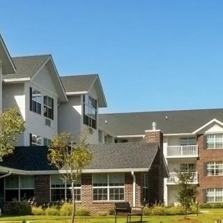 A residential apartment building with modern architecture under a clear blue sky.