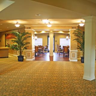 Spacious and elegantly designed lobby area featuring comfortable furnishings and decorative plants.