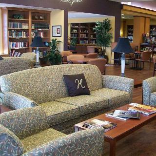 Cozy library interior with sofas and bookshelves.