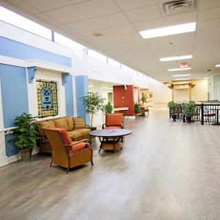 A serene and welcoming hallway featuring comfortable seating and decorative elements.