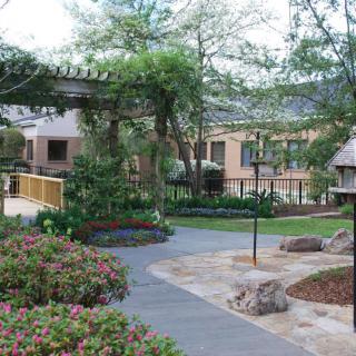 A beautifully landscaped garden with a winding pathway and lush greenery.