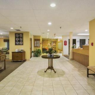 A spacious hotel lobby with a central table and welcoming decor.