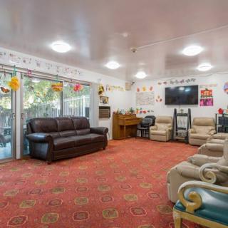 A cozy living room with multiple sofas, a television, and festive decorations.