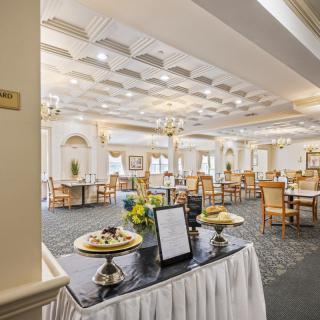 An elegant dining room with neatly arranged tables and chairs, featuring stylish decor and lighting.