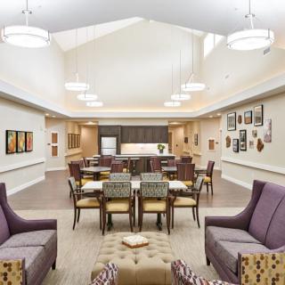 A modern and spacious dining area with elegant seating arrangements and contemporary lighting.