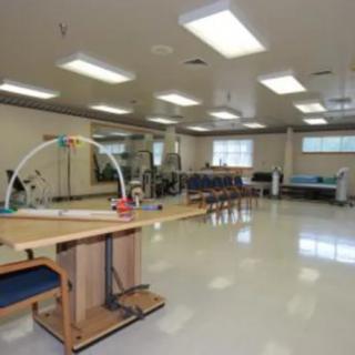A spacious physical therapy room equipped with various exercise equipment.