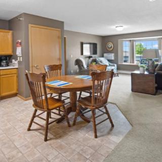 Open concept living room and dining area with wooden furniture.