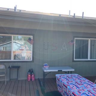 A backyard setup with tables and party decorations.