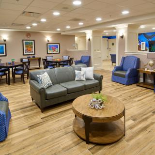 A cozy and well-lit living room area with comfortable seating and stylish decor.