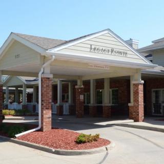 Entrance to a retirement home with brick and siding architecture.