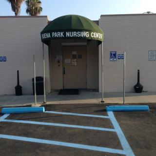 Entrance to a nursing center with designated handicap parking.